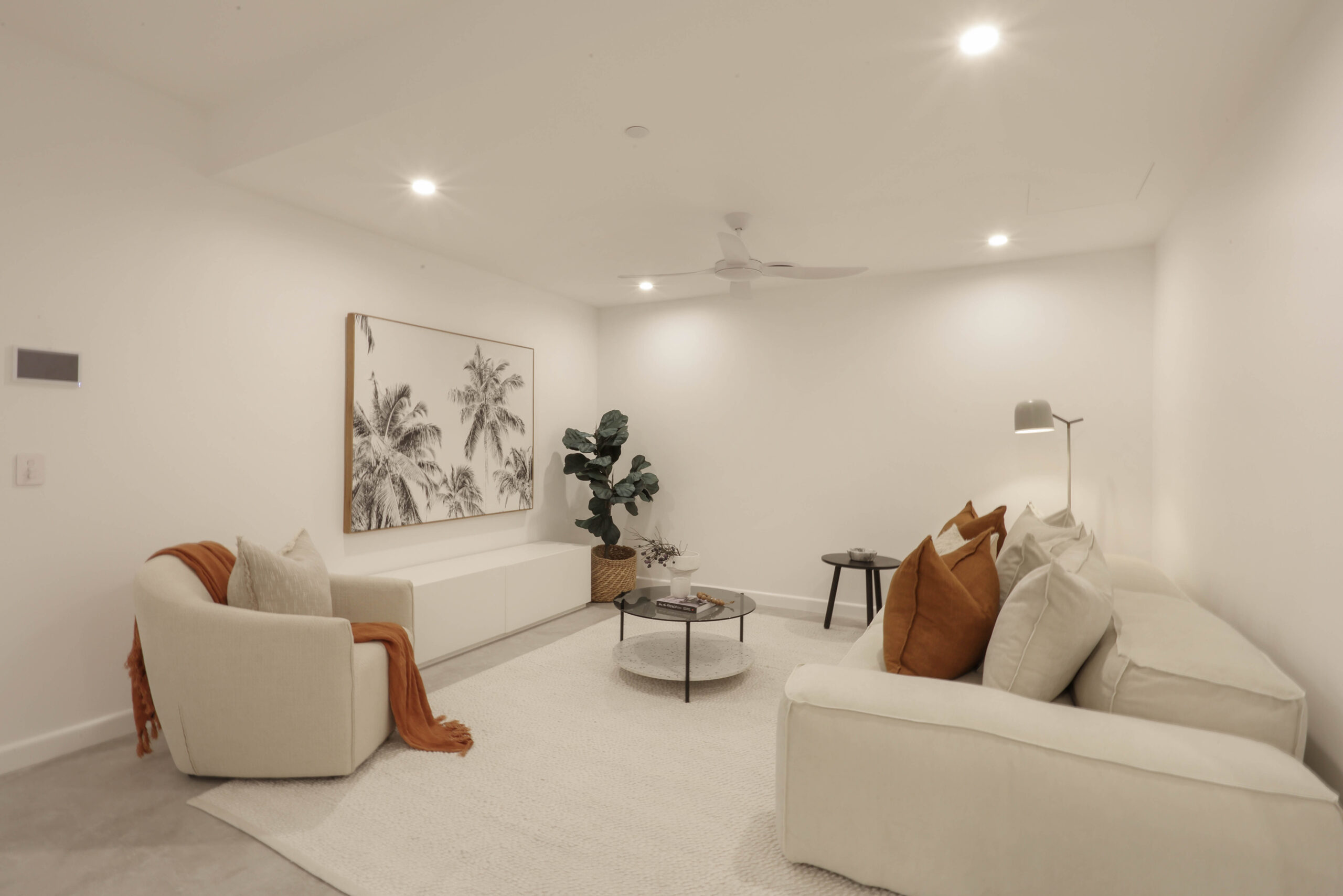 white furniture in a media room, property styling by blink living