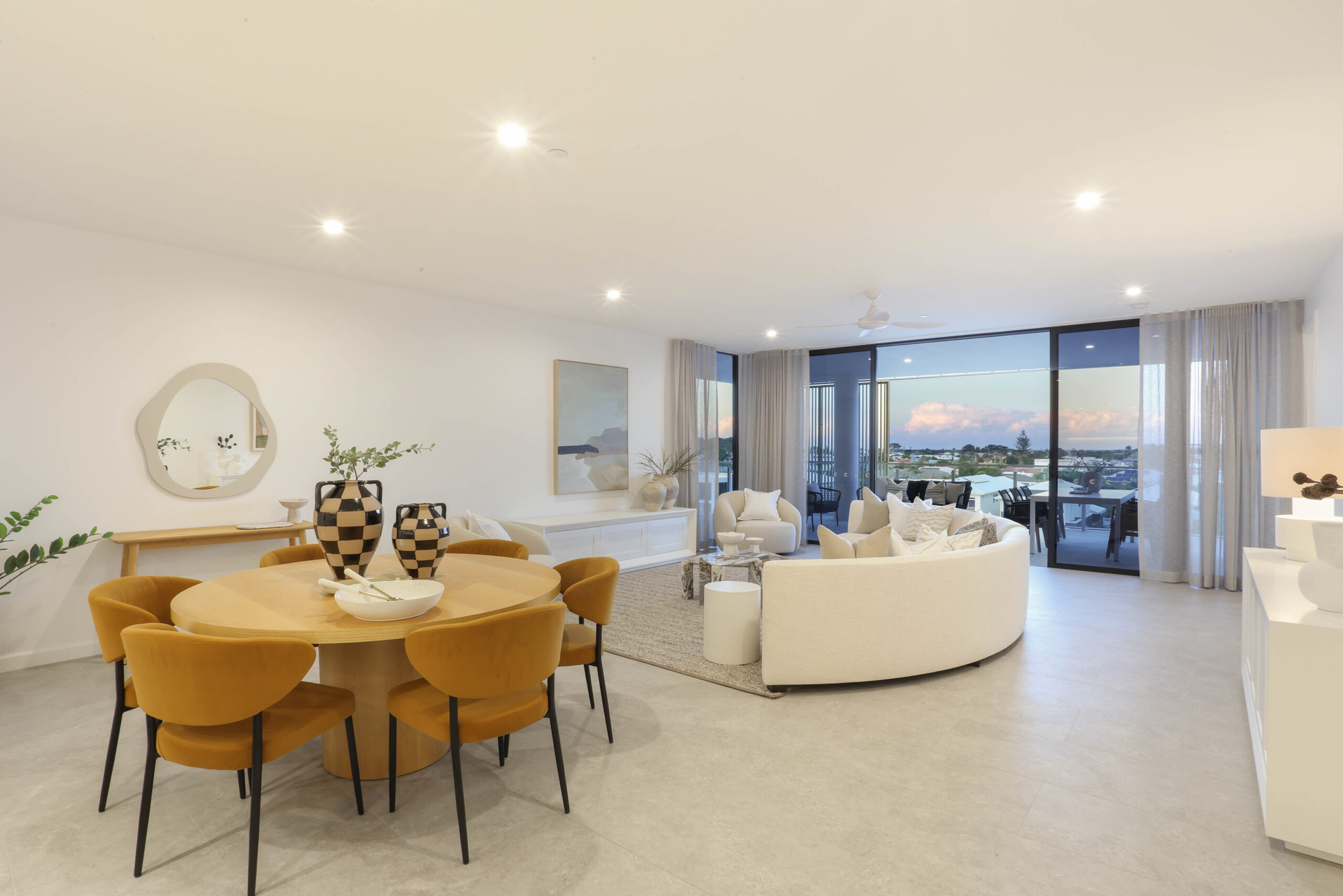orange velvet dining chairs in a white contemporary apartment, property styling by blink living